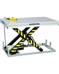 Silver static scissor lift table with yellow and black safety stripes, equipped with a motor and control box for lifting heavy loads in industrial settings.